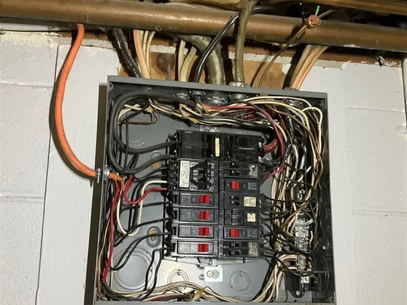 Open electrical panel in a basement during an AVL Inspections inspection