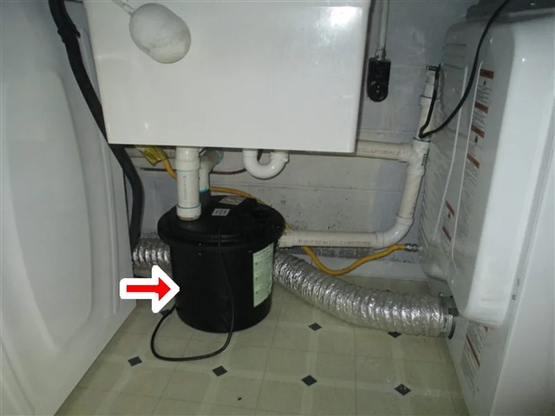Basement pump marked with a red arrow in an AVL Inspections report
