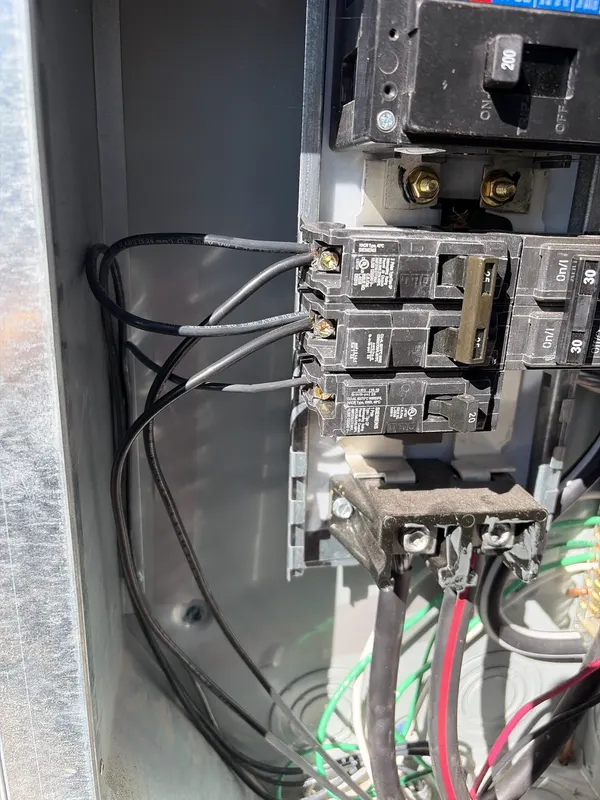 Open electrical panel being checked during an AVL Inspections inspection