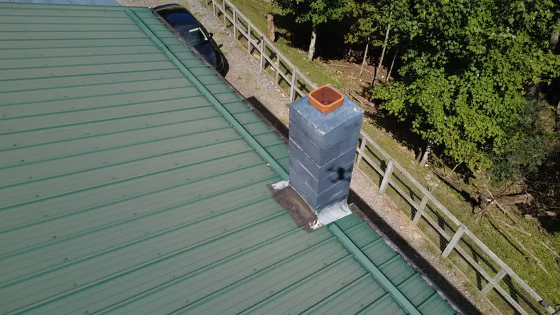 A chimney on a standing seam metal roof