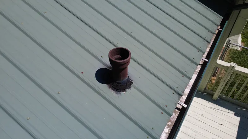 Drone photo of a vent pipe on a metal roof